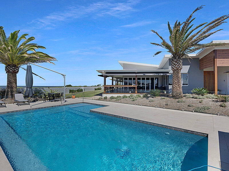 Coastal home with large inground pool by Donemans Pools